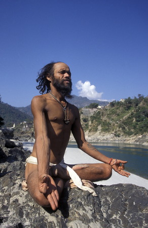 a men on the Ganges River in the town of Rishikesh in the Province Uttar Pradesh in India.のeditorial素材