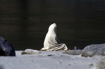a men on the Ganges River in the town of Rishikesh in the Province Uttar Pradesh in India.のeditorial素材