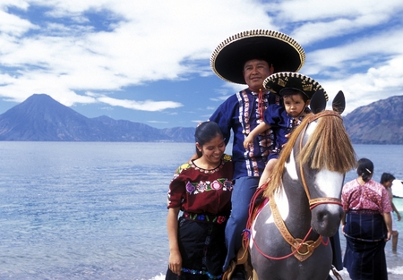 People at the coast of Lake Atitlan mit the Volcanos of Toliman and San Pedro in the back at the Town of Panajachel in Guatemala in central America.のeditorial素材