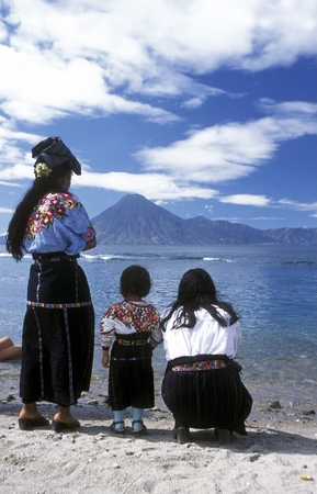 People at the coast of Lake Atitlan mit the Volcanos of Toliman and San Pedro in the back at the Town of Panajachel in Guatemala in central America.のeditorial素材