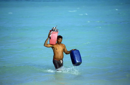 a Fisherman on the way from the Boat to the Village of Las Terrenas on Samanaon in The Dominican Republic in the Caribbean Sea in Latin America.のeditorial素材