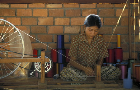 a weaving women working in a farmer village outside of the city of phnom penh cambodia in in Southeastasia.のeditorial素材