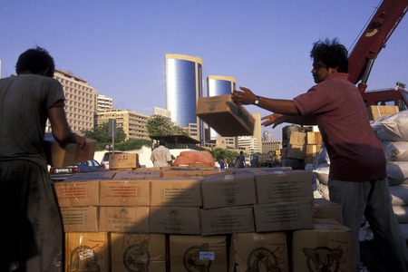 Import and export goods at the harbour at the Dubai creek in the old town in the city of Dubai in the Arab Emirates in the Gulf of Arabia.のeditorial素材