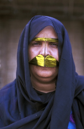 a portrait of a Arab women in the souq or Market in the old town in the city of Dubai in the Arab Emirates in the Gulf of Arabia.のeditorial素材