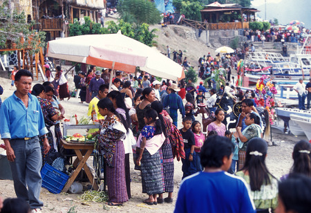 people at the Lake Atitlan mit the Volcanos of Toliman and San Pedro in the back at the Town of Panajachel in Guatemala in central America.のeditorial素材