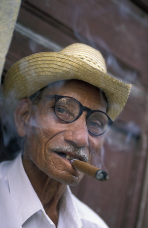 a signor with a cigar in the city of Santiago de Cuba on Cuba in the caribbean sea.のeditorial素材