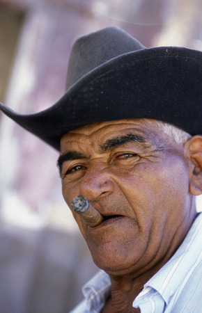 a signor with a cigar in the city of Santiago de Cuba on Cuba in the caribbean sea.のeditorial素材