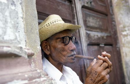 a signor with a cigar in the city of Santiago de Cuba on Cuba in the caribbean sea.のeditorial素材