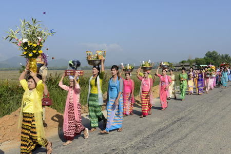 People in traditional dresses at a shinpyu ceremony in a village neat the city of Myeik in the south in Myanmar in Southeastasia.のeditorial素材