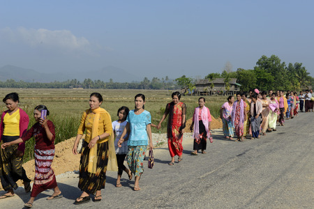 People in traditional dresses at a shinpyu ceremony in a village neat the city of Myeik in the south in Myanmar in Southeastasia.のeditorial素材