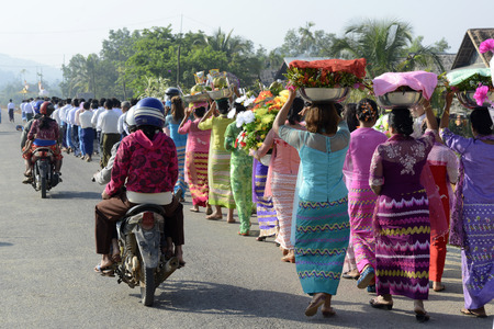 People in traditional dresses at a shinpyu ceremony in a village neat the city of Myeik in the south in Myanmar in Southeastasia.のeditorial素材