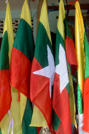 Mayanmar Flags at the municipal market in the city of Myeik in the south in Myanmar in...