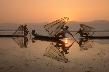 Fishermen at sunrise in the Landscape on the Inle Lake in the Shan State in the east of Myanmar in Southeastasia.のeditorial素材