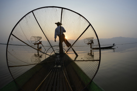 Fishermen at sunrise in the Landscape on the Inle Lake in the Shan State in the east of Myanmar in Southeastasia.のeditorial素材
