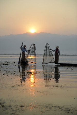 Fishermen at sunrise in the Landscape on the Inle Lake in the Shan State in the east of Myanmar in Southeastasia.のeditorial素材
