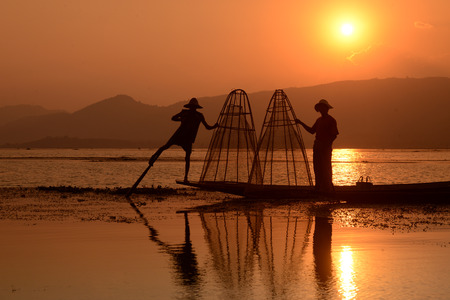 Fishermen at sunset in the Landscape on the Inle Lake in the Shan State in the east of Myanmar in Southeastasia.のeditorial素材