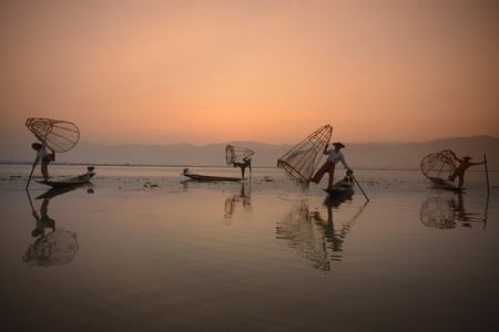 Fishermen at sunrise in the Landscape on the Inle Lake in the Shan State in the east of Myanmar in Southeastasia.のeditorial素材