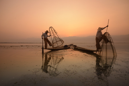 Fishermen at sunrise in the Landscape on the Inle Lake in the Shan State in the east of Myanmar in Southeastasia.のeditorial素材