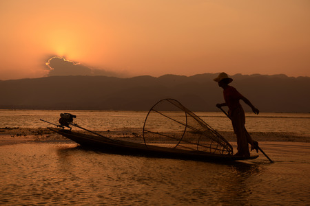 Fishermen at sunrise in the Landscape on the Inle Lake in the Shan State in the east of Myanmar in Southeastasia.のeditorial素材