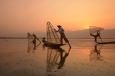 Fishermen at sunrise in the Landscape on the Inle Lake in the Shan State in the east of Myanmar in Southeastasia.のeditorial素材