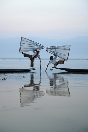 Fishermen at sunrise in the Landscape on the Inle Lake in the Shan State in the east of Myanmar in Southeastasia.のeditorial素材