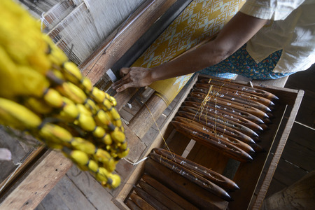 a women in a traditional weaving workshop Factory near the Village of Phaung Daw Oo at the Inle Lake in the Shan State in the east of Myanmar in Southeastasia.のeditorial素材