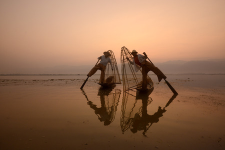 Fishermen at sunrise in the Landscape on the Inle Lake in the Shan State in the east of Myanmar in Southeastasia.のeditorial素材