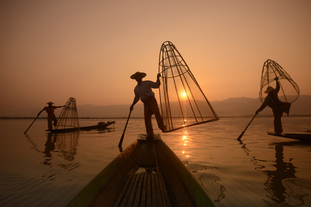Fishermen at sunrise in the Landscape on the Inle Lake in the Shan State in the east of Myanmar in Southeastasia.のeditorial素材