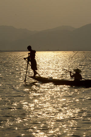 Fishermen at sunset in the Landscape on the Inle Lake in the Shan State in the east of Myanmar in Southeastasia.のeditorial素材