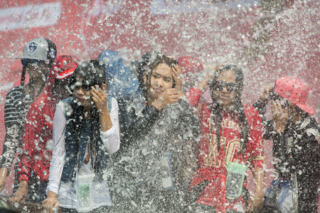 People at the Waterparty at the Thingyan Water Festival at the Myanmar New Year in the city centre of Mandalay in Manamar in Southeastasia.のeditorial素材