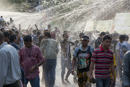 People at the Waterparty at the Thingyan Water Festival at the Myanmar New Year in the city centre of Mandalay in Manamar in Southeastasia.のeditorial素材