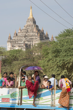 Myanmar Tourista on a Truckbus Taxi in front of a  Temple and Pagoda  in Bagan in Myanmar in Southeastasia.のeditorial素材