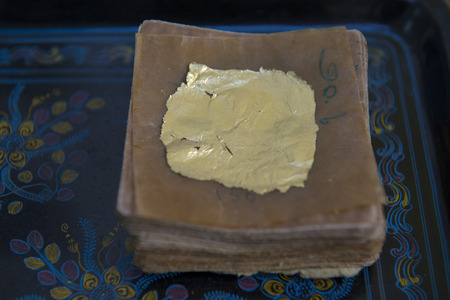 sheets of Gold leaf at a Gold pounder Factory the City of Mandalay in Myanmar in Southeastasia.のeditorial素材