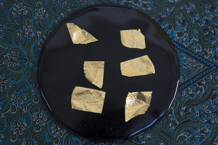 sheets of Gold leaf at a Gold pounder Factory the City of Mandalay in Myanmar in Southeastasia.の写真素材