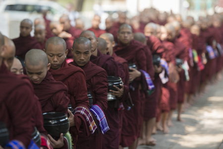 monks are on the way to the lunch at the Mahagandayon Monastery in Amarapura near the City of Mandalay in Myanmar in Southeastasia.のeditorial素材