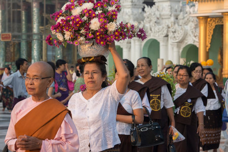 people on a ceremony at the Shwedagon Paya Pagoda in the City of Yangon in Myanmar in Southeastasia.