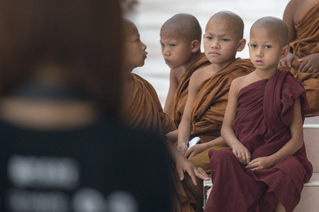 young monks in the Shwedagon Paya Pagoda in the City of Yangon in Myanmar in Southeastasia.のeditorial素材