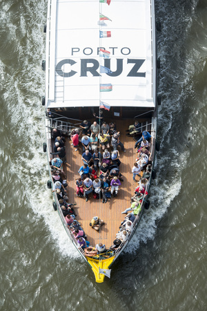 a tourist boat on the Douro River in Ribeira in the city centre of Porto in Porugal in Europe.のeditorial素材