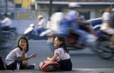 school childern on a road in the city of ho chi minh city in Vietnamのeditorial素材
