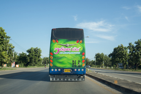 a tour bus in the city centre of Udon Thani in the Isan in Northeast Thailand.のeditorial素材