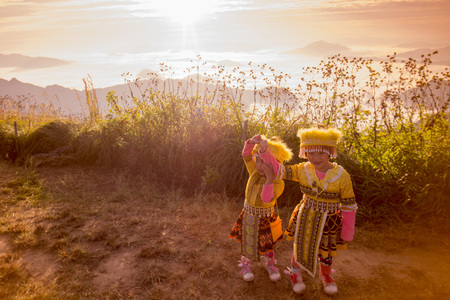 childern of the Hill Tribe of Hmong enjoy at the Cliff of Phu Chi Fa in the Chiang Rai Province in North Thailand.のeditorial素材