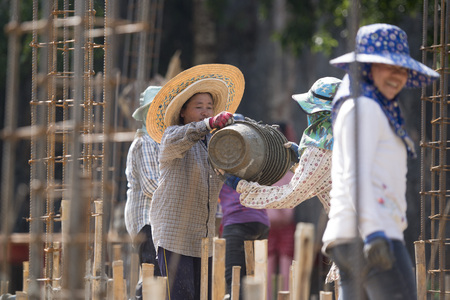 women at a construction of a house near the city Chiang Rai in North Thailand.のeditorial素材