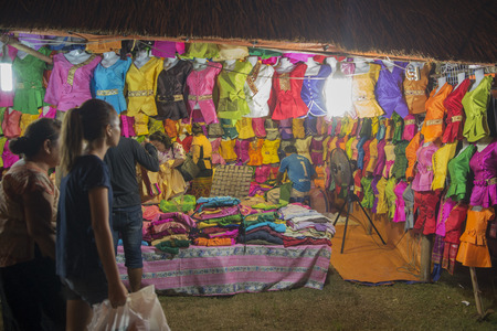 a clothes shop at the market at the Pha That Luang Festival in the city of vientiane in Laos in the southeastasia.のeditorial素材