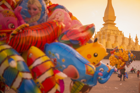 a Balloon saler at the Pha That Luang Festival in the city of vientiane in Laos in the southeastasia.のeditorial素材