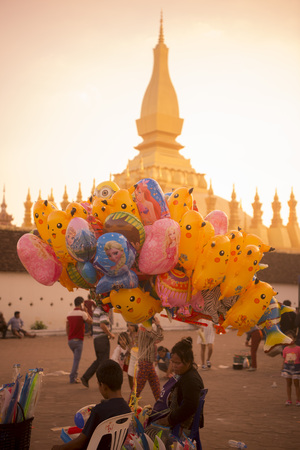 a Balloon saler at the Pha That Luang Festival in the city of vientiane in Laos in the southeastasia.のeditorial素材