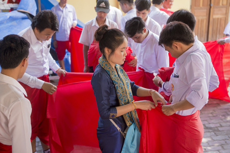 People at a ceremony at the Wat Si Muang Temple on the That Luang Festival in the city of vientiane in Laos in the southeastasia.のeditorial素材