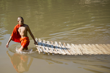 the construction of the Bamboo Bridge over the Nam Khan river in the town of Luang Prabang in the north of Laos in Southeastasia.のeditorial素材