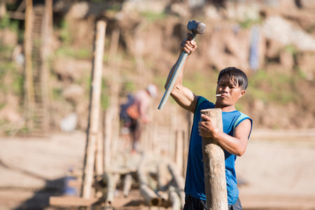 the construction of the Bamboo Bridge over the Nam Khan river in the town of Luang Prabang in the north of Laos in Southeastasia.のeditorial素材