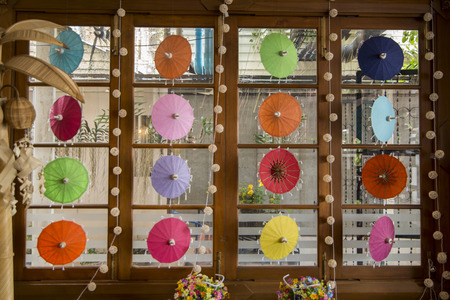 a window with paper Umbrella Decoration in a Gusthouse in the city of Bangkok in Thailand.の写真素材