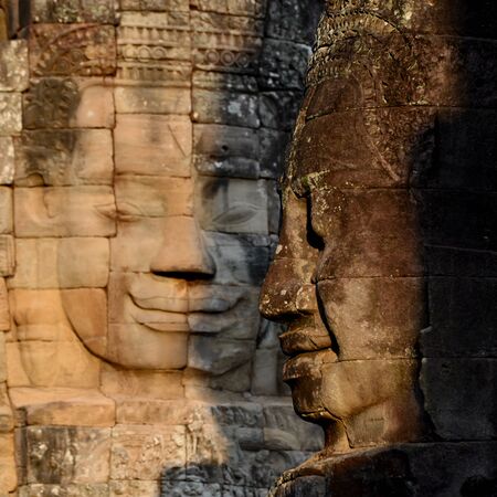 Stone face at the Bayon Temple the Tempel Ruins of Angkor Thom in the Temple City of Angkor near the City of Siem Reap in the west of Cambodia.  Cambodia, Siem Reap, April 2014のeditorial素材